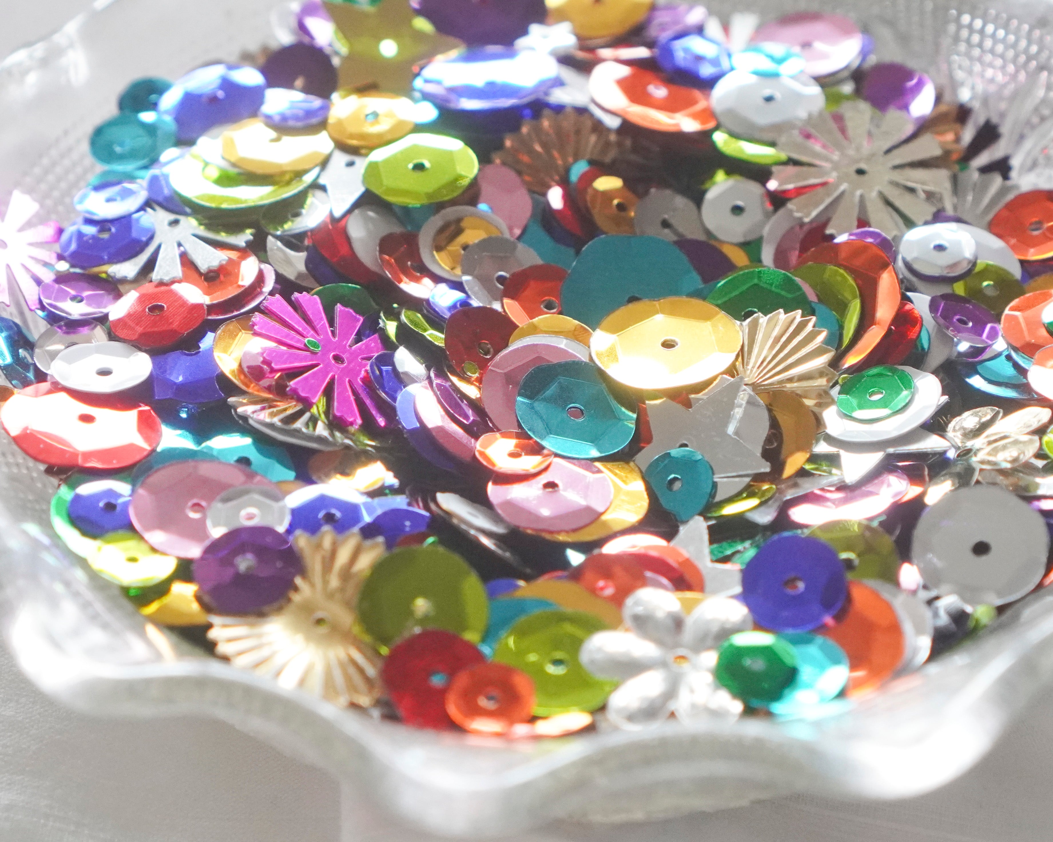 Assorted colorful sequins on a plate