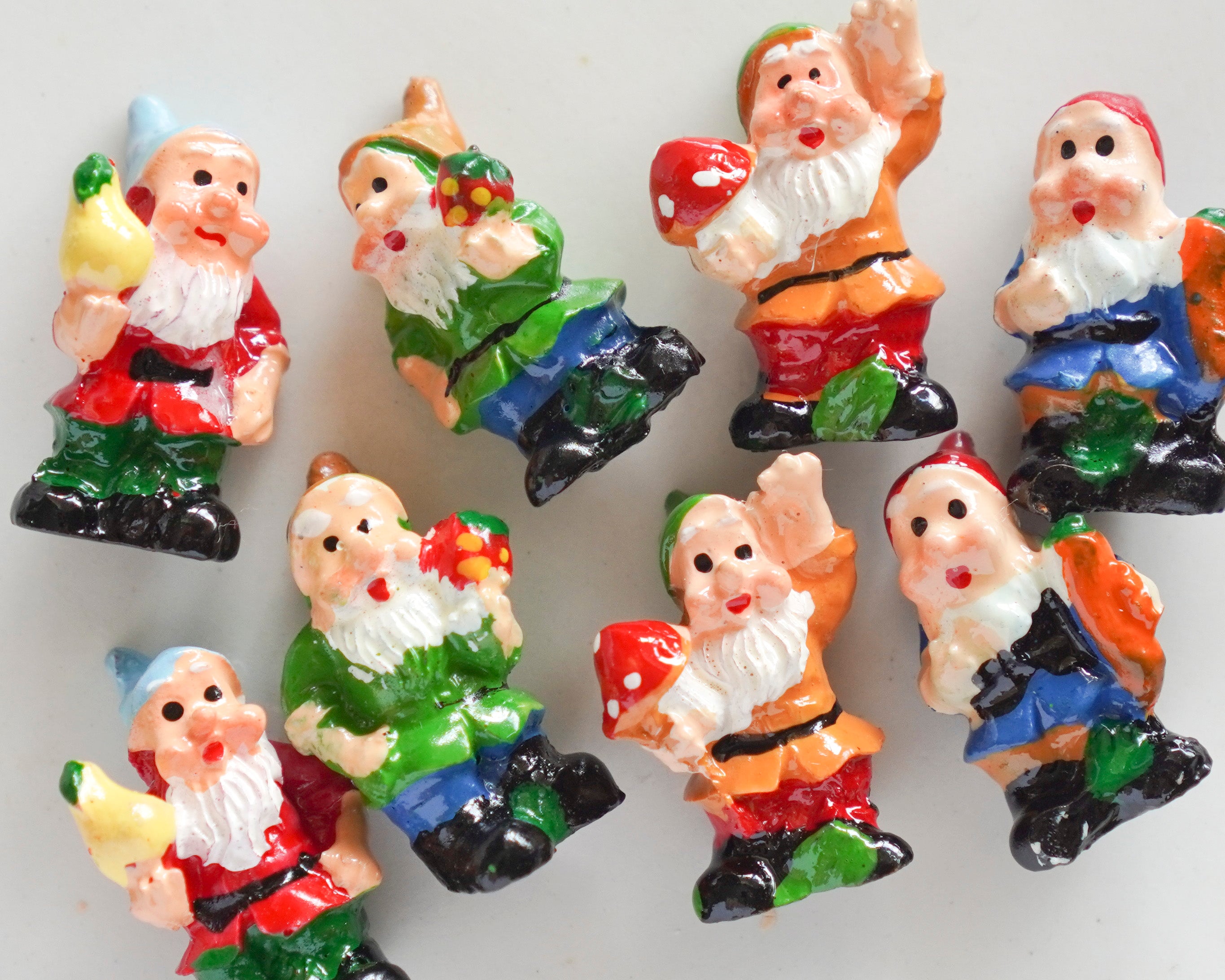 Set of colorful gnome figurines on a white background