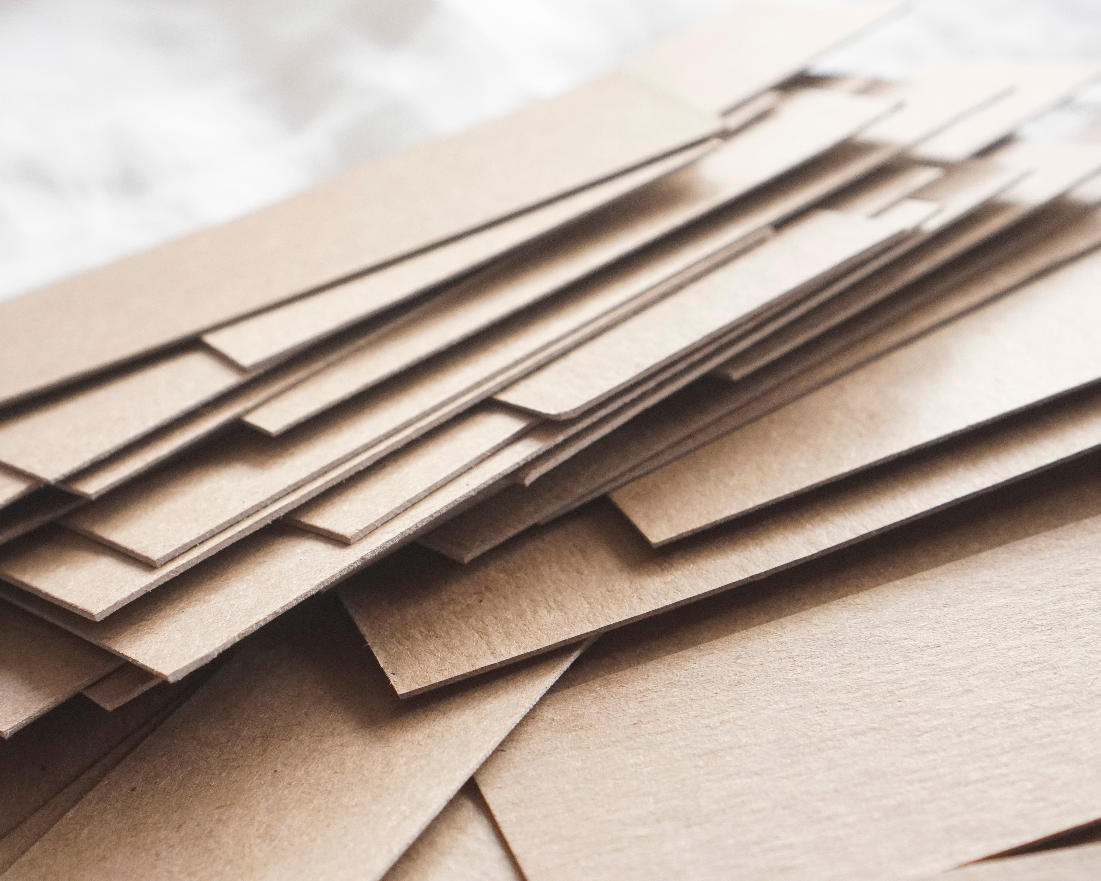 Stack of brown chipboard sheets on a white background
